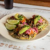 Panuchos · Single Fried homemade corn tortilla stuffed with black beans puree, topped with grilled chic...