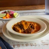 Cochinita Pibil · Sucking pork meat marinated with achiote and sour orange wrapped and baked in banana leaves.