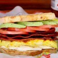 Wakie Bakie Sandwich · 2 eggs, cheddar, tomatoes, avocado, tapatio, cream cheese, bacon and or sausage. Toasted gar...