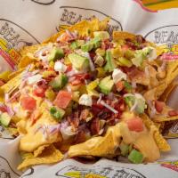 Marley Nachos · Tomatoes, onions, pepperoncinis, avocado, bacon and cream cheese.
