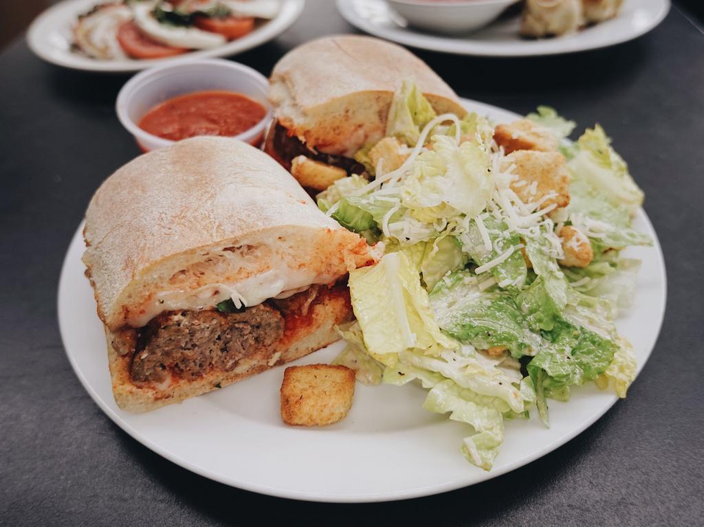 Sal's Meatball Sandwich · House-made meatballs covered in fresh marinara and mozzarella and oven baked. Served on toasted Artisan local bakery roll with a side salad.