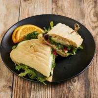 Goat Cheese Sandwich · Goat cheese with roasted red peppers, cucumber, olives, arugula and oregano infused oil on b...