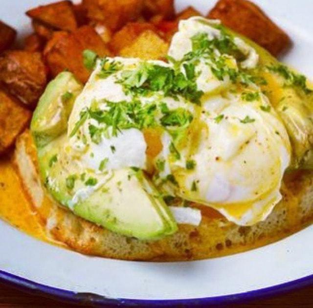 Veggie Benedict · Piled with avocado, tomato and housemade hollandaise on english muffin | Served with crispy breakfast potato wedges