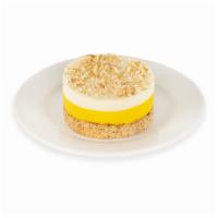 Coco Mango Mousse Cake · Almond sponge cake and mango mousse topped with whip cream and toasted coconut.