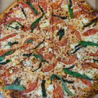 Marguerite Pizza · Feta cheese, tomatoes, basil, extra virgin olive oil.