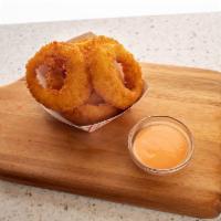 Onion Rings · Thick cut onions, battered and fried with a light dusting of salt