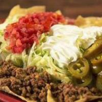 Nacho Supremos · Frontera’s corn or flour chips smothered in cheese dip, refried beans, ground beef, lettuce,...