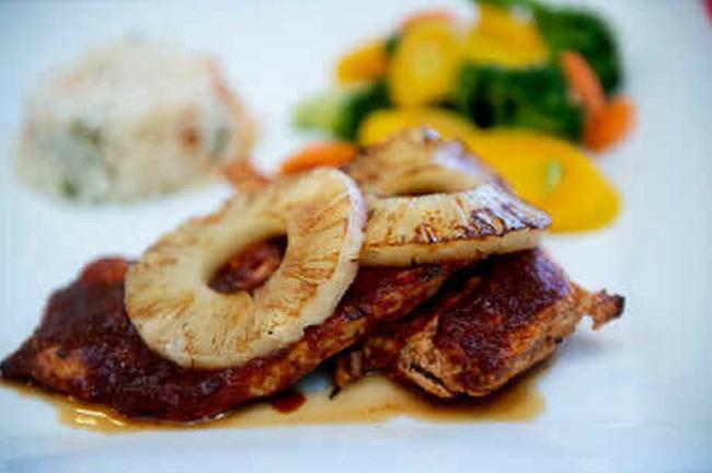 Tropical Chicken Breast · Boneless premium chicken marinated in mild guajillo red sauce. Served with white rice and steamed veggies.