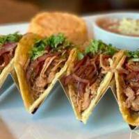 Tacos De Brisket · Slow-cooked with XX Amber beer, signature sweet pickled red onions, and fresh cilantro. Serv...