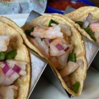 Baja Shrimp Tacos · Grilled crispy shrimp tacos filled with Chihuahua cheese, diced poblanos and grilled onions....