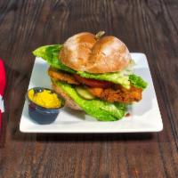 Pork Chop Hot Sandwich · Pan-fried breaded pork chop with spicy mayo, lettuce, tomato, and pickles.