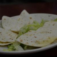 Cheese quesadillas · Flour tortillas folded and filled with melted Mexican cheese. Served with sour cream