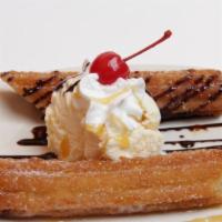 Bunuelos · Deep-fried dough dipped in brown sugar and cinnamon. Served with chocolate, caramel and whip...