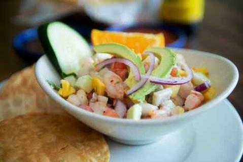 Ceviche Tropical · Tilapia and shrimp marinated and cured in freshly squeezed lime juice. Mixed with tomato, cilantro, avocado, mango, cucumber, green apple and red onion.