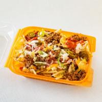 Nacho's · Crunchy tortilla chips, ground beef, creamy cheese sauce, salsa and 1 specialty topping of y...