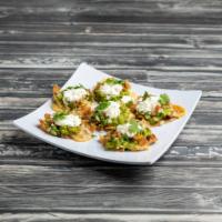 Nacho · Small crisp tortillas topped with refried beans, melted chihuahua cheese, guacamole, pico de...
