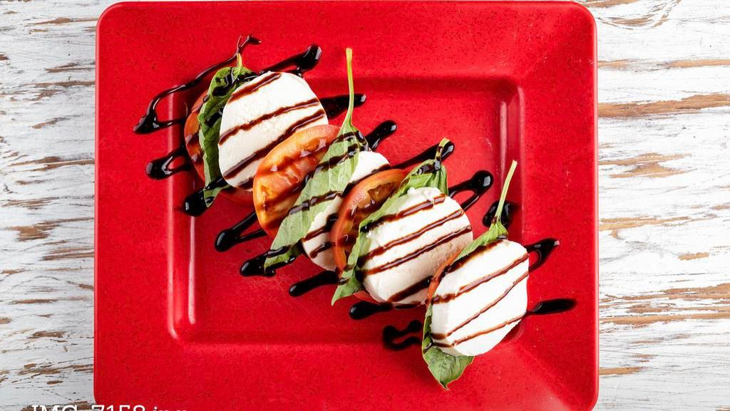 Caprese Salad · Fresh mozzarella, beefsteak tomatoes, basil, balsamic glaze and a drizzle of extra-virgin olive oil.