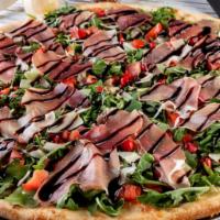 Fresh Arugula Pizza · Prosciutto, fresh arugula, sliced tomatoes, shaved Parmesan and sweet peppers topped with ex...