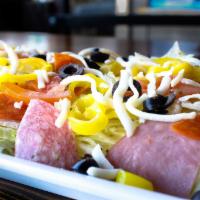 THE ITALIAN SALAD · Chopped iceberg topped with pepperoni, genoa salami, ham, black olives, tomatoes, and banana...