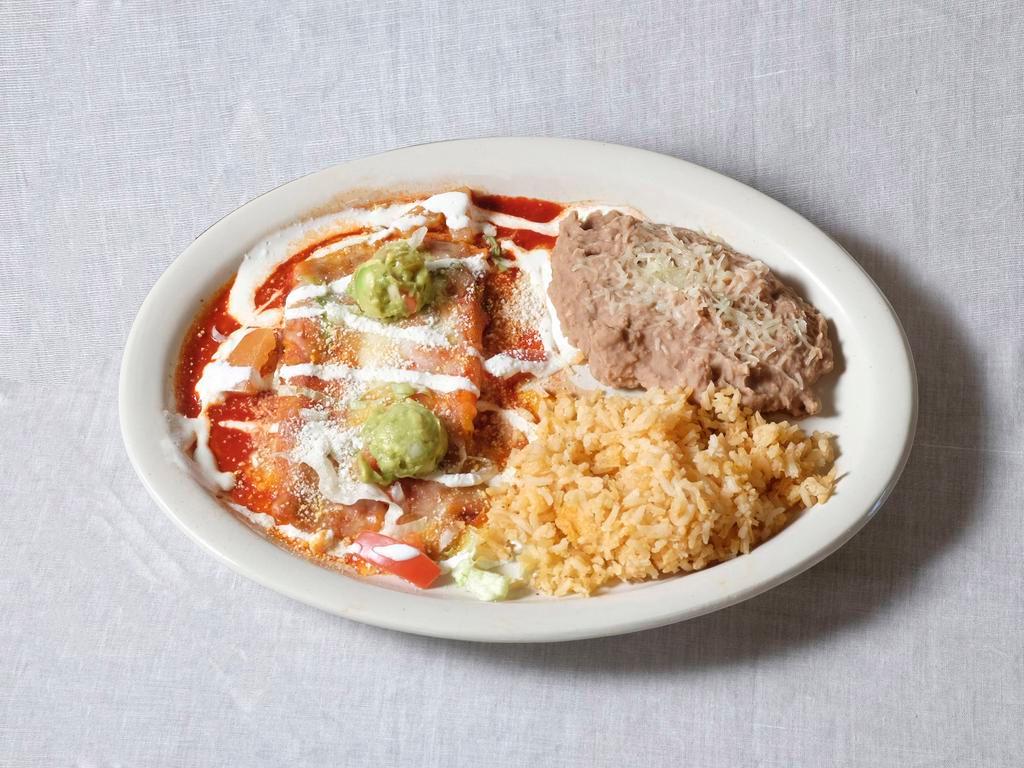 Chicken Michoacan Style Enchiladas · Corn tortillas rolled with wither sauce and cojita cheese. Garnished with lettuce tomatoes, onions and sour cream. Served with side.