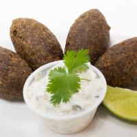 Kibbeh · Beef croquettes made with finely ground meat, cracked wheat, mint leaves, pine nuts, onions,...