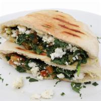 Spinach Feta Empanadas · Spinach, Feta cheese and tomatoes, baked in a pita bread served with garlic sauce 