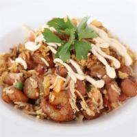 Shrimp Rice Bowl · Shrimp, Basmati Rice with Foul Moudamas, tomatoes and fresh herbs, topped with fried onions