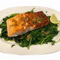 Grilled Salmon · Grilled Salmon with a lemon garlic sauce, served on top of Sautee Spinach