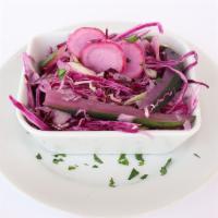 Pickled Vegetables · Sweet and tangy, thinly sliced radish, julienned cucumbers, white and red cabbage.