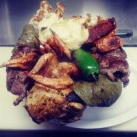 Plato Molcajete · combination of beef stake, chicken, chorizo, shrimps, grilled cactus, grilled peppers, onion...