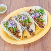 Tacos de Asada · 3 steak tacos grilled with cilantro and onions, served in your choice of tortillas. Served w...