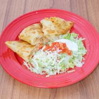 Quesadillas · Cooked tortilla that is filled with cheese and folded in half. Pull chicken, ground beef or ...