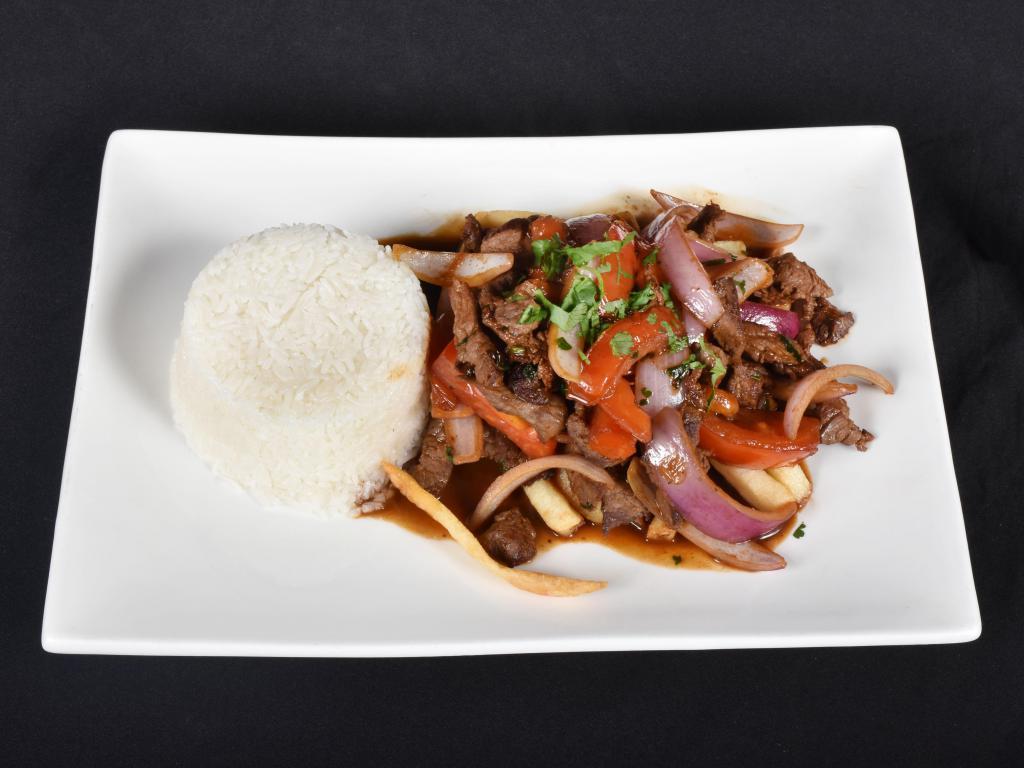 25. Lomo Saltado · Stir fried sirloin tip steak sauteed with soy sauce wine, onions, green peppers and tomatoes. Served with fries and rice. 