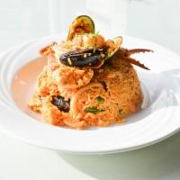 54. Arroz con Mariscos · Peruvian style paella with seafood served with yellow rice and mixed vegetables.