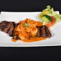 60. Mar y Tierra · Surf and turf. Sirloin steak topped with garlic shrimp.