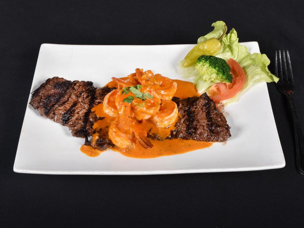 60. Mar y Tierra · Surf and turf. Sirloin steak topped with garlic shrimp.