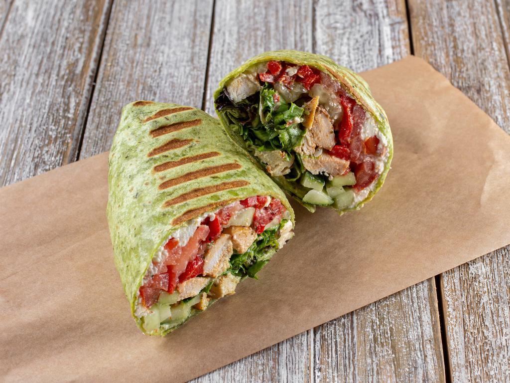 Pesto Chicken Wrap · Baby greens, romaine, cucumber, tomato, roasted peppers, feta cheese, chicken breast, basil pesto and olive oil dressing.