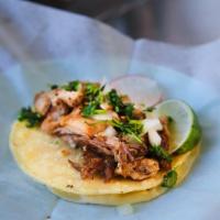 Carnitas Taco · Pork simmered in water and spices until tender, then shredded.
