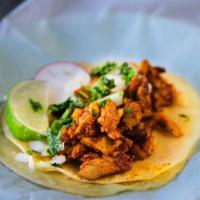 Pollo Pibil Taco · Traditional Mexican dish from the Yucatan in which chicken is smothered with Achiote paste a...
