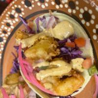 Fish Taco · Beer battered fried  fish on a bed of cabbage then topped with pico de gallo and salsa Sinal...