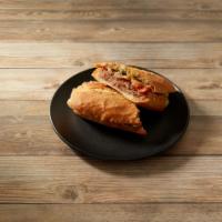 Res Torta · Hollowed out bolillo roll filled with beans, shredded beef, lettuce, tomatoes, onions and gu...