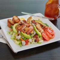 Cobb Salad · Romaine lettuce topped with crispy bacon, avocado, heirloom tomatoes, boiled egg, blue chees...