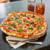 Margherita Pizza · Fresh mozzarella, Roma tomatoes, pesto basil. Vegan. Vegetarian.