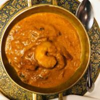 Prawn Curry · Prawns cooked with onion, ginger, garlic, turmeric and other Indian spices.