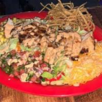 Southwest Chicken Salad · Lettuce topped with sweet corn, shredded cheese, pico de gallo, and char-grilled chicken. Se...