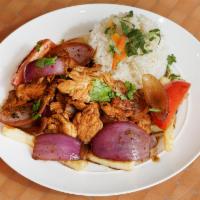 Pollo Saltado · Tender chicken with sauteed onions and tomatoes, served with fries and rice.