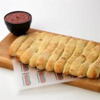 Guido Bread · Try our golden-brown baked bread sticks. Topped with melted butter, Parmesan Cheese, and gar...