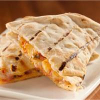 Chicken Quesadilla · Grilled chicken, cheese, onions, green chiles, chipotle sauce folded into a warm tortilla, s...