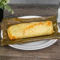 Chicken Tamales · Steamed tamal wrapped in a banana leaf, filled with chicken.