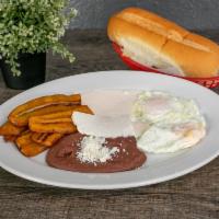 Desayuno Tradicional Breakfast · Fried plantain, refried beans, sour cream, cheese, two eggs any style. Served with two torti...